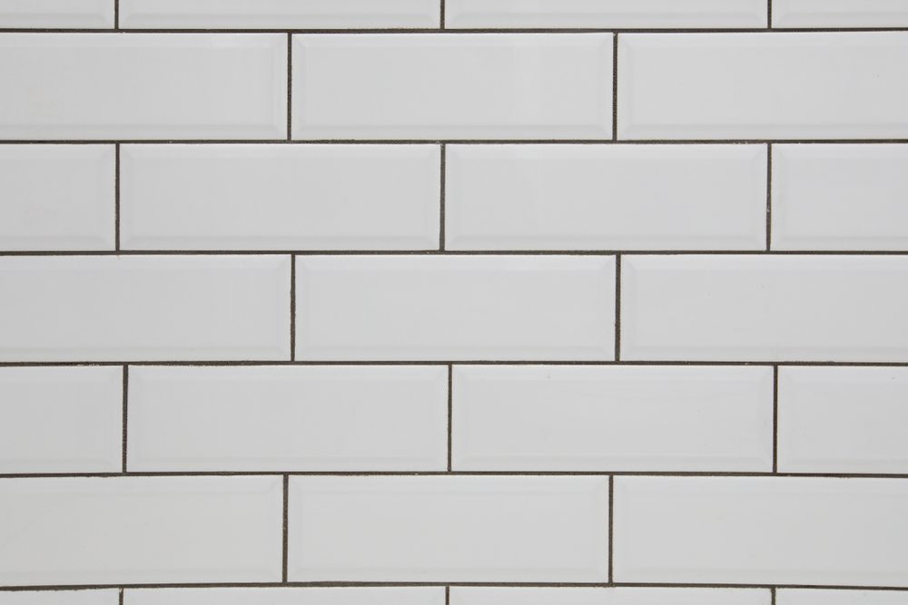 White subway tile wall and dark grout for a kitchen or bathroom backsplash
