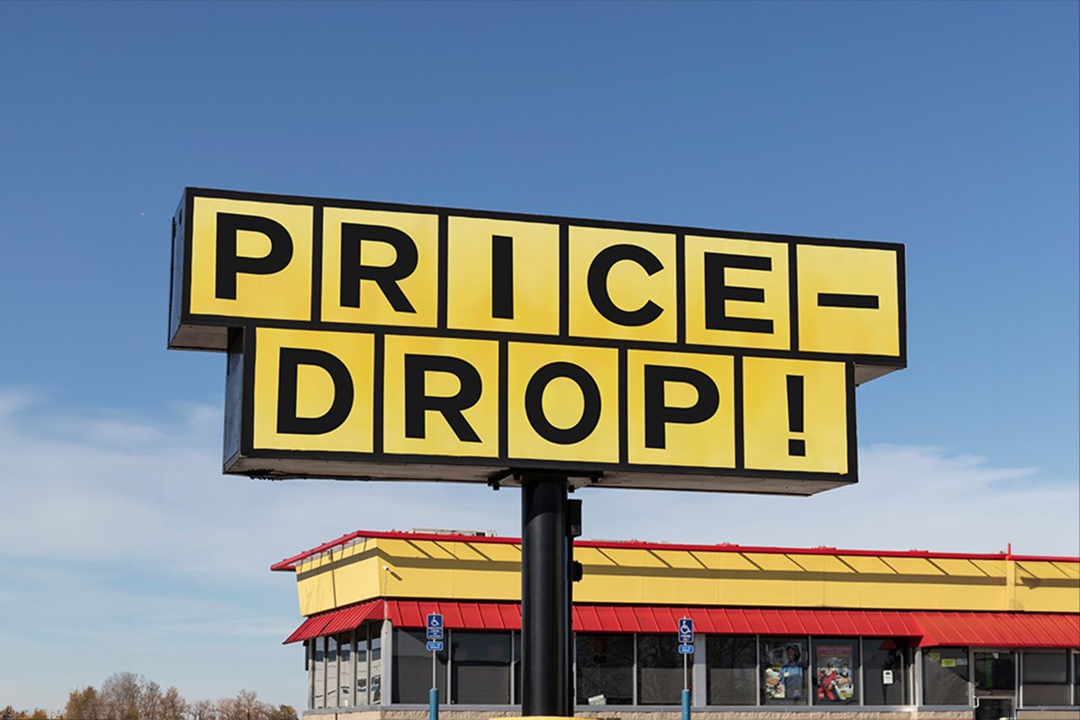 A hoarding of price drop infront of a building